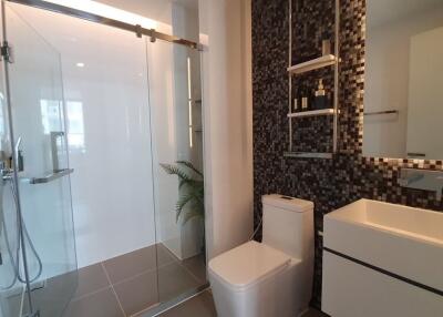 Modern bathroom with glass shower enclosure and sleek vanity