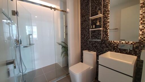 Modern bathroom with glass shower enclosure and sleek vanity