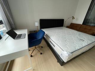 Modern bedroom with bed, desk, and chair