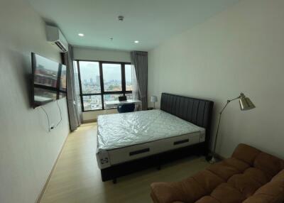 Spacious bedroom with large window and city view