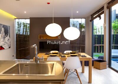 Modern kitchen and dining area with view of private swimming pool