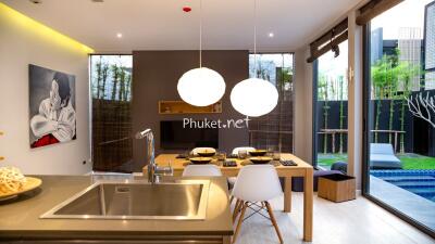 Modern kitchen and dining area with view of private swimming pool