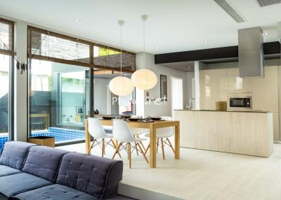 Modern kitchen with dining area and pool view