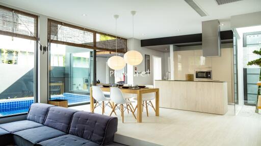 Modern kitchen with dining area and pool view