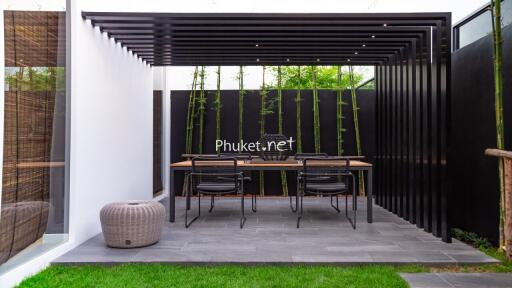 Modern outdoor dining space with pergola