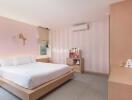 Modern bedroom with striped accent wall, bed, wall-mounted TV, and air conditioning