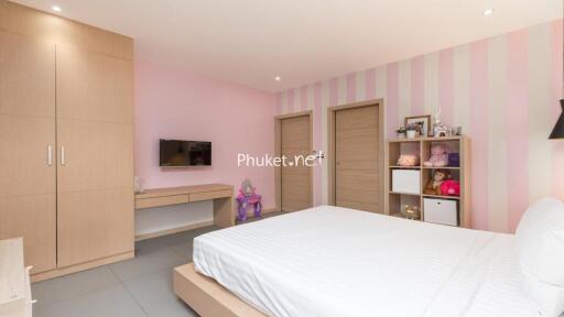 Modern and cozy bedroom with pastel pink striped wall and built-in wardrobe