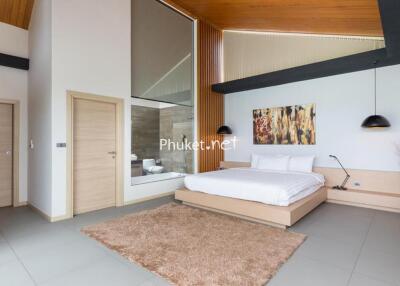 Modern bedroom with platform bed, artwork, and large glass window