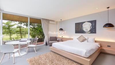 Modern bedroom with large window and Buddha wall art