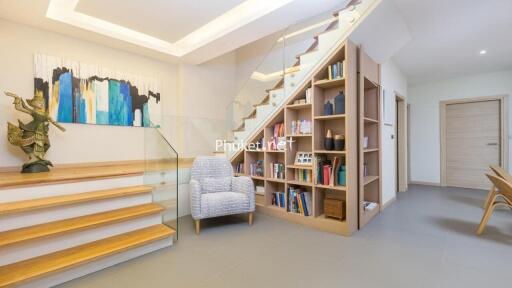 Modern living area with staircase and built-in bookshelves