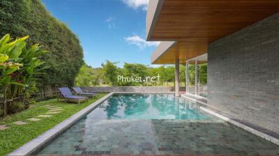 Outdoor pool area with lounge chairs and greenery