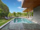 Outdoor pool area with lounge chairs and greenery