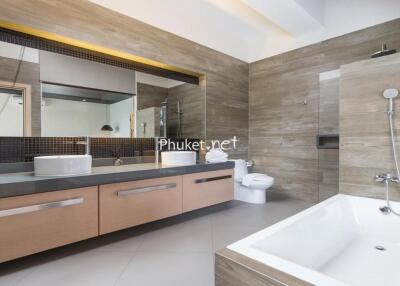 Modern bathroom with bathtub and dual sinks