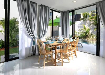 Modern dining area with large windows and garden view