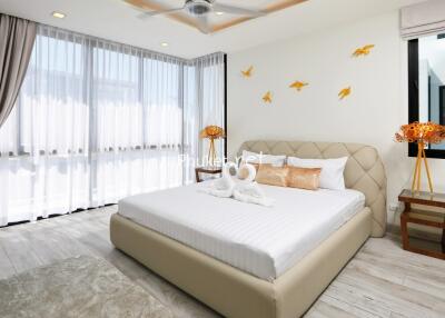 Modern bedroom with ample natural light and stylish decor