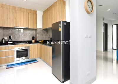 Modern kitchen with wooden cabinets and stainless steel appliances