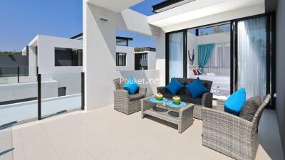 Modern balcony with outdoor seating and a view of the building