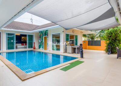 Outdoor pool area with shaded seating