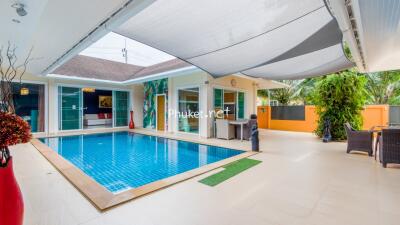 Outdoor pool area with shaded seating