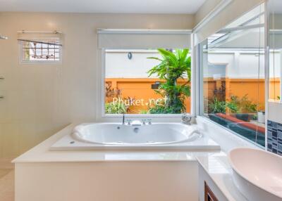 Modern bathroom with large bathtub and window view