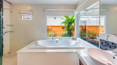 Modern bathroom with large bathtub and window view