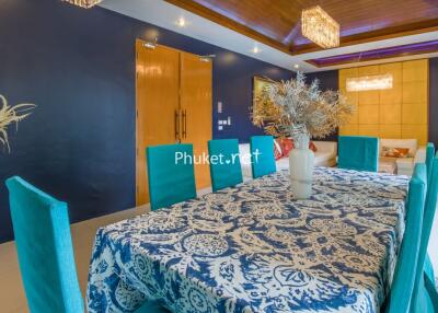 Bright dining room with blue chairs and a patterned tablecloth