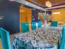 Bright dining room with blue chairs and a patterned tablecloth