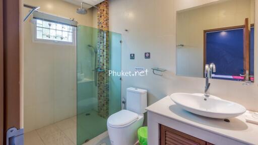 Modern bathroom with glass shower and white sink