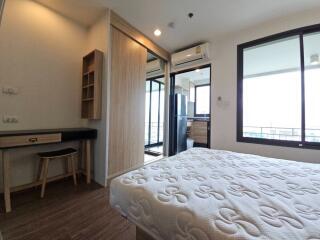 Modern bedroom with attached workspace and balcony