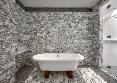 Luxury bathroom with freestanding tub and marble walls