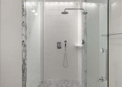 Modern bathroom with marble accents and glass shower enclosure