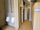 Modern bathroom with urinals and stall doors