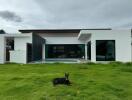 Modern house with large windows and green lawn