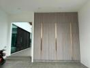 Spacious modern entrance with wood paneling and glass walkway