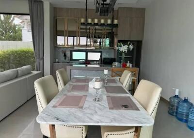 Modern dining area with marble table and stylish beige chairs