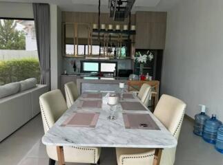 Modern dining area with marble table and stylish beige chairs