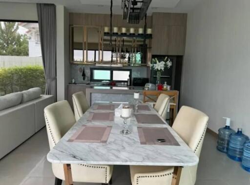 Modern dining area with marble table and stylish beige chairs