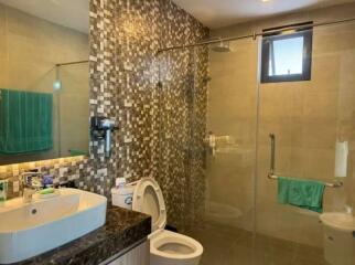 Modern bathroom with glass shower and mosaic tiles