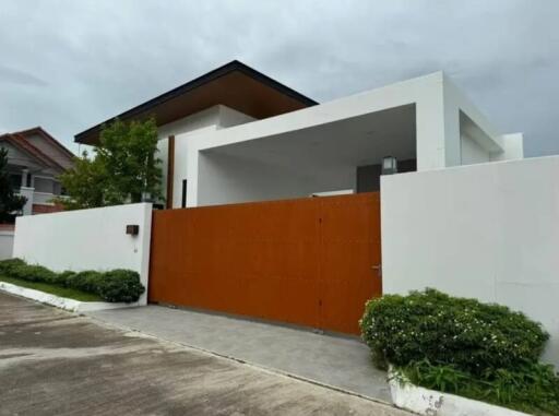 Modern house exterior with a large wooden gate