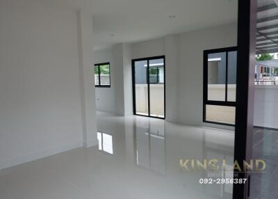 Modern living area with large windows and glossy tiled floors