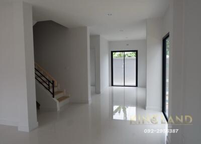 Modern living room with staircase and large windows