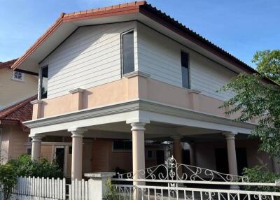 Two-story house with a white fence