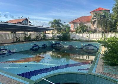 Swimming pool with tiled design and adjacent buildings