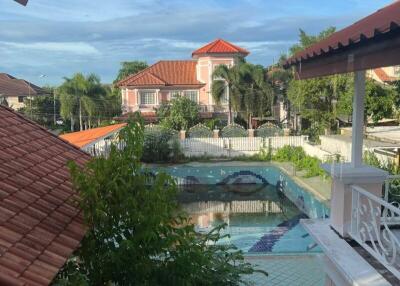 View of a property with a pool and neighboring houses