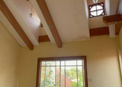 Spacious living room with high ceilings and glass doors