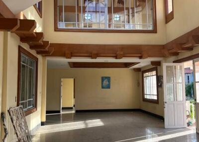 spacious living room with large windows and high ceiling