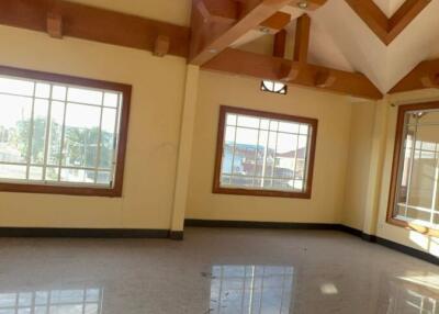 Spacious living room with wooden beams and large windows