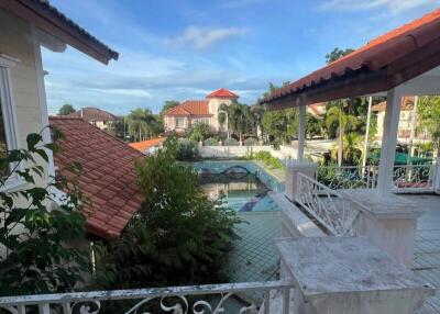 Balcony with a view of a pool and neighboring houses