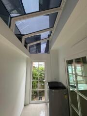 Utility room with washing machine and glass ceiling