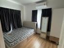 Bedroom with bed, mirror, air conditioning, and wooden floor